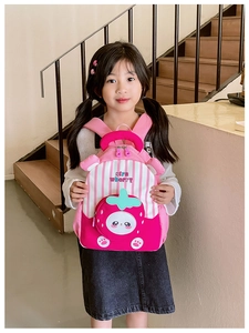Close-up of strawberry themed backpack featuring pink stripes and 3D fruit pocket