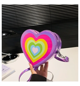 Detail of heart-shaped crossbody bag with rainbow layers and purple laser finish