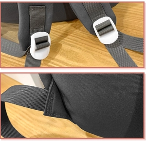 Detail of durable backpack strap adjustment buckle and reinforced stitching on gray canvas