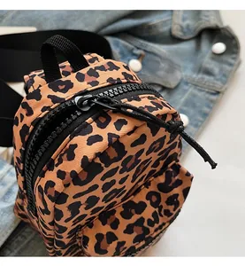 Macro shot of smooth black zipper and leopard print fabric on a mini backpack