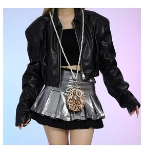 Detail of leopard print heart bag with pearls and bow on a leather jacket outfit