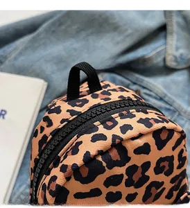Detail shot of leopard print canvas bag featuring a heavy-duty black zipper and nylon handle