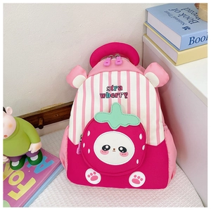 Detail of cute strawberry pocket with cartoon face on a pink striped kids backpack