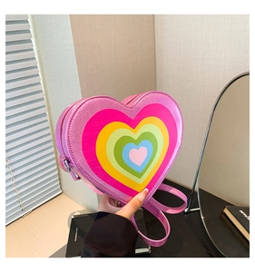 Detail of heart-shaped crossbody bag with rainbow heart pattern and glitter pink finish