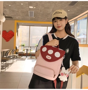 Detail of pink canvas mushroom backpack with white polka dots and cute bunny pendant