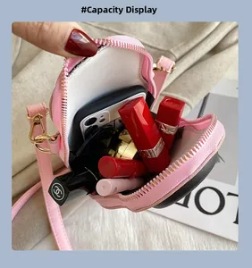 Macro view of a pink heart-shaped bag showing interior capacity for phone and lipsticks