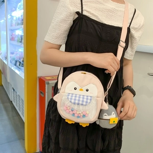 Cute pink penguin crossbody bag with colorful pom-poms and matching plush charm