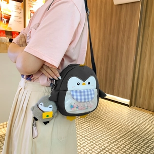Cute cartoon penguin crossbody bag with colorful pom-poms and white lace details
