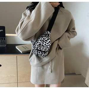 Detail of mini black and white leopard print chest bag with adjustable nylon strap