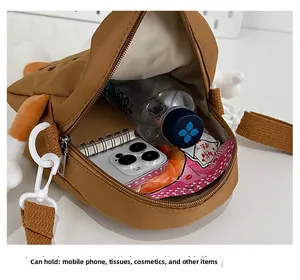 Interior view showing the large capacity of the brown cartoon crossbody bag for kids