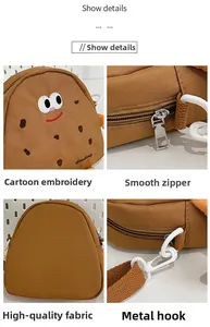Details of cartoon biscuit shoulder bag showing embroidery, zipper, and strap hooks
