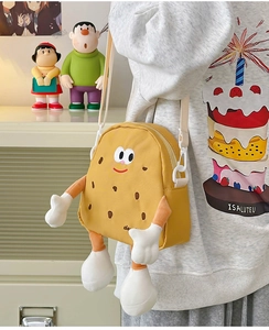 Detail of yellow cookie-shaped crossbody bag for kids with 3D limbs and cute face