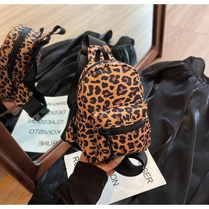 Detailed close-up of mini leopard print chest bag with adjustable black nylon strap