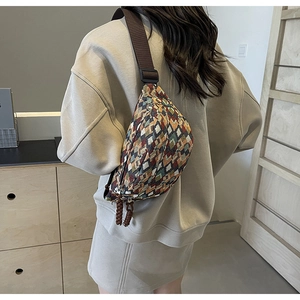 Close-up of geometric woven crossbody chest bag with colorful vintage folk patterns