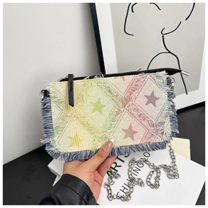 Detail of denim fringe chain bag with colorful gradient star pattern and silver metal chain