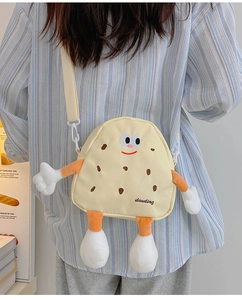 Detail of cute cookie canvas crossbody bag with 3D limbs and adjustable shoulder strap