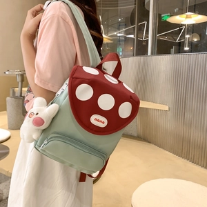 Kawaii mushroom backpack in mint green with red polka dot lid and rabbit pendant