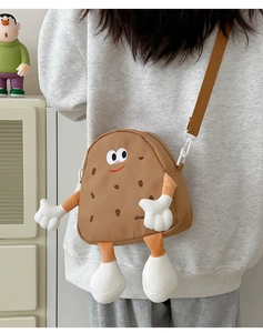 Detail of children's brown cartoon biscuit crossbody bag showing 3D arms and legs