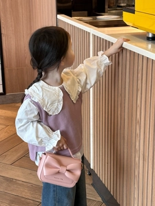 Détail d'un sac à main rose pour filles avec grand nœud et tenue élégante pour enfant