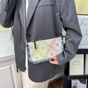 Rainbow denim chain bag with star pattern and fringe tassels on a stylish model