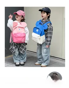 Detailed view of color-block kids backpacks with cute round ears and patch accents