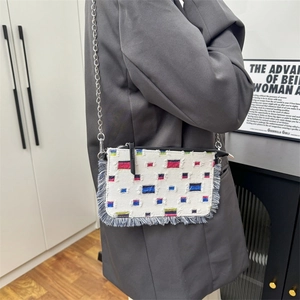 Fashionable denim shoulder bag with colorful patchwork and elegant silver chain strap