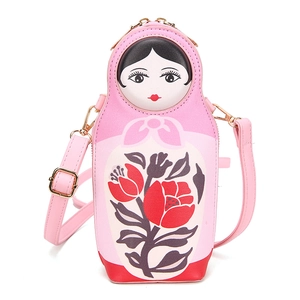 Pink Matryoshka-shaped crossbody bag with floral patterns and adjustable strap