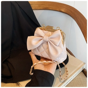 Détail du sac bandoulière rose matelassé avec grand nœud et fermoir en métal doré