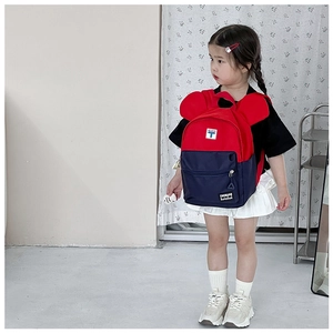Detailed view of child wearing colorful canvas backpack with cute round ears design