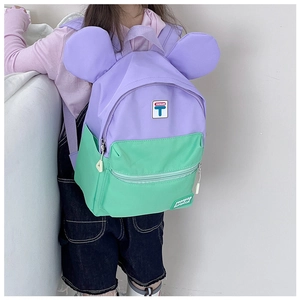 Detail of colorful purple and green kids backpack with cute big round ears design