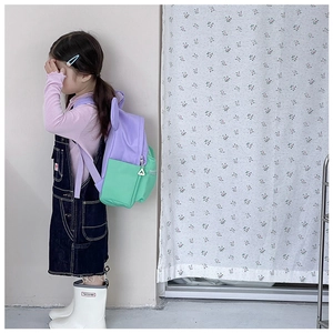 Close-up of children's color-block backpack featuring cute ears and side zipper detail