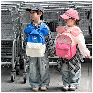Close-up of kids backpack with cartoon large round ears and stylish color blocking