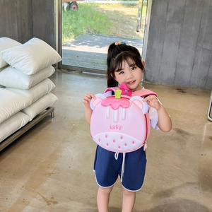 Pink cartoon strawberry children backpack in eggshell shape held by a young girl