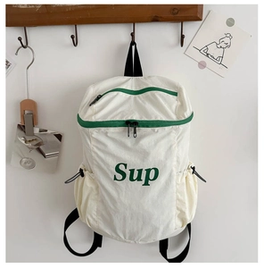 Détail du sac à dos enfant en nylon avec logo Sup vert, poches latérales et zips