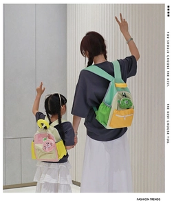 Detailed view of color-block backpacks for adults and kids with cute animal pendants