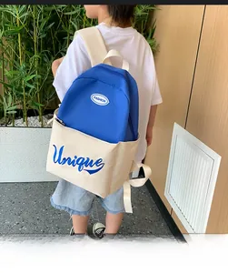 Rear view of a child wearing the blue and white large capacity school backpack