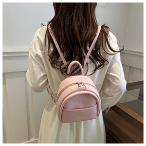 Detail of pink PU leather mini backpack for children with silver metal zippers and straps