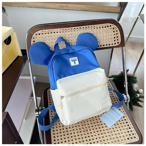 Close-up of kids backpack featuring cute 3D ears and contrast blue and white panels