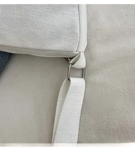 Close-up of the silver metal buckle and durable canvas strap on a child's shoulder bag
