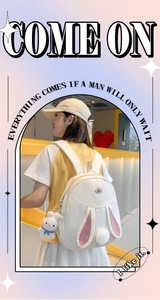 Detail showing white rabbit-themed backpack with pink ears and plush tail decoration