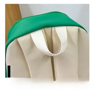 Close-up of a wide canvas handle on a green and beige large school backpack