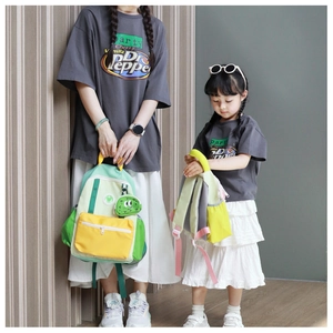 Detailed view of color-block backpack set for parent and child with cute mascot pendant