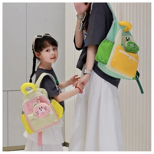 Matching parent-child nylon backpacks in vibrant color-block design with cute pendants