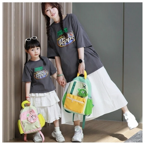 Detail of color-block kids backpack with cute animal pendant and matching casual t-shirts