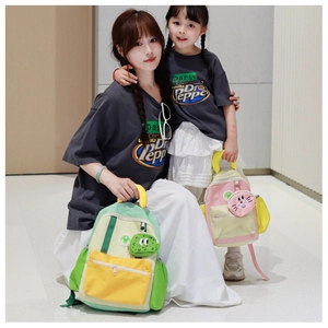 Detail view of colorful contrast backpacks in green and pink with cute cartoon pendants
