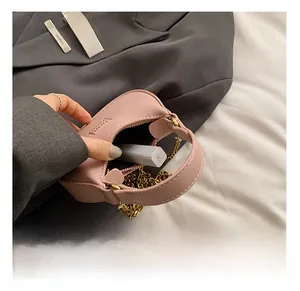 Pink mini leather chain bag interior showing space for a lipstick and small essentials