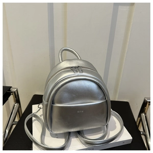 Detail view of mini silver PU backpack with top handle and adjustable straps