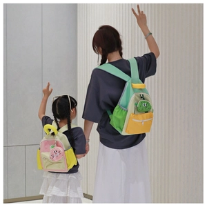 Detail of color-block canvas backpacks for parent and child with cute cartoon patches