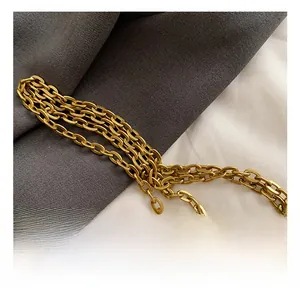 Close-up of elegant gold metal chain strap on a pink leather crossbody children bag