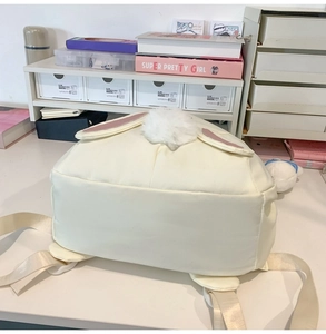 Close-up of cream bunny backpack featuring plush tail and 3D ears detail